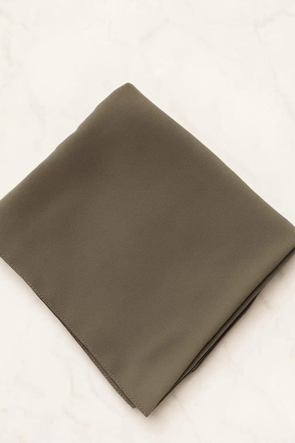 Olive brown Marjeena premium jersey hijab draped smoothly, showcasing soft fabric and elegant style.